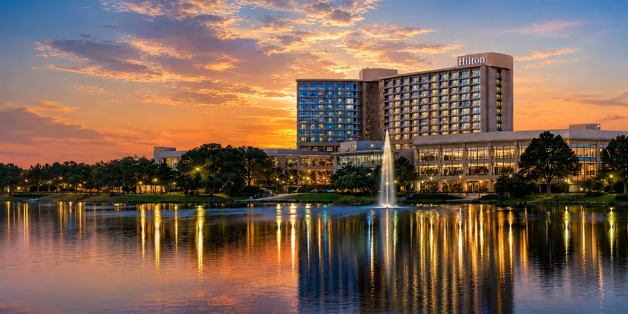Hilton DFW Lakes Executive Conference Center at sunset, overlooking the lake with fountain